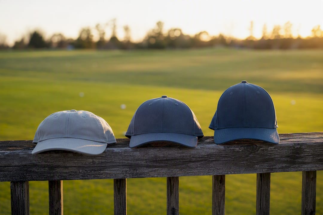 Three golf hats showing low, mid and high crown heights