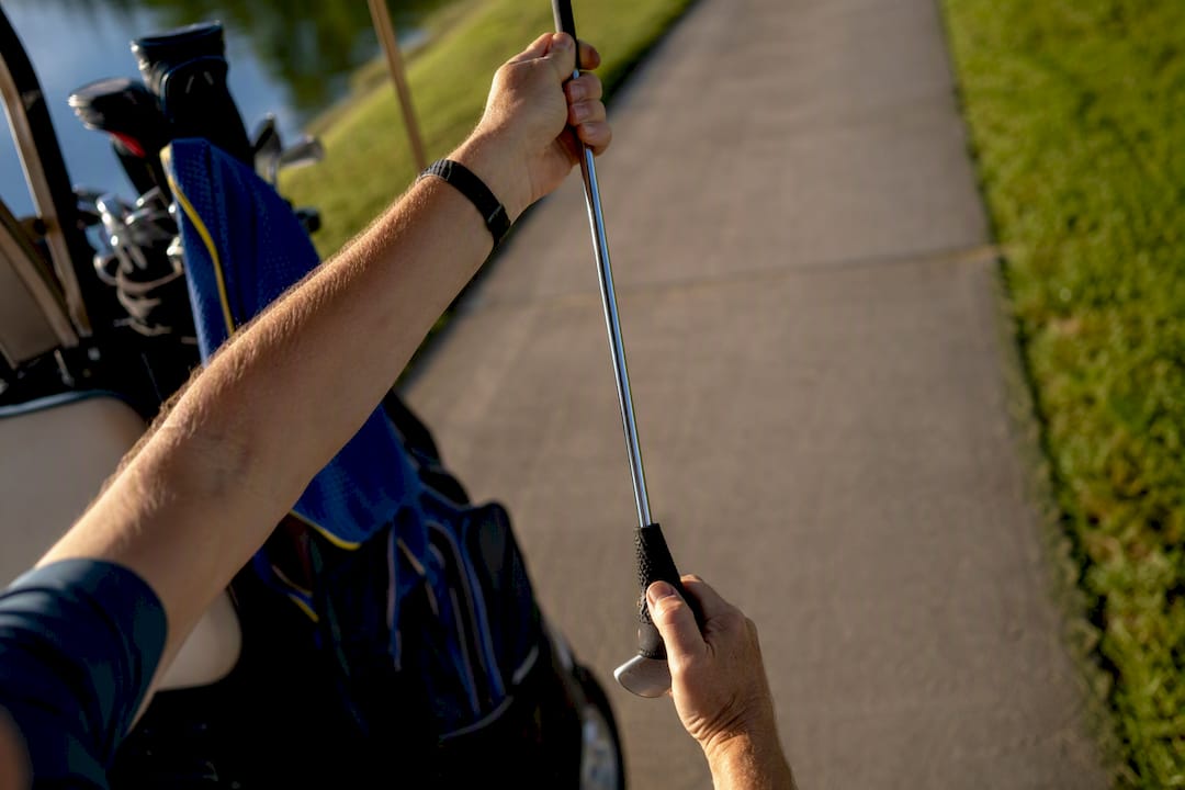 Hands checking headcover retention upside down