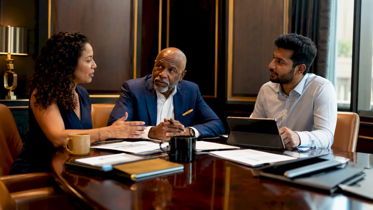 Business team discussing loan conversion at table