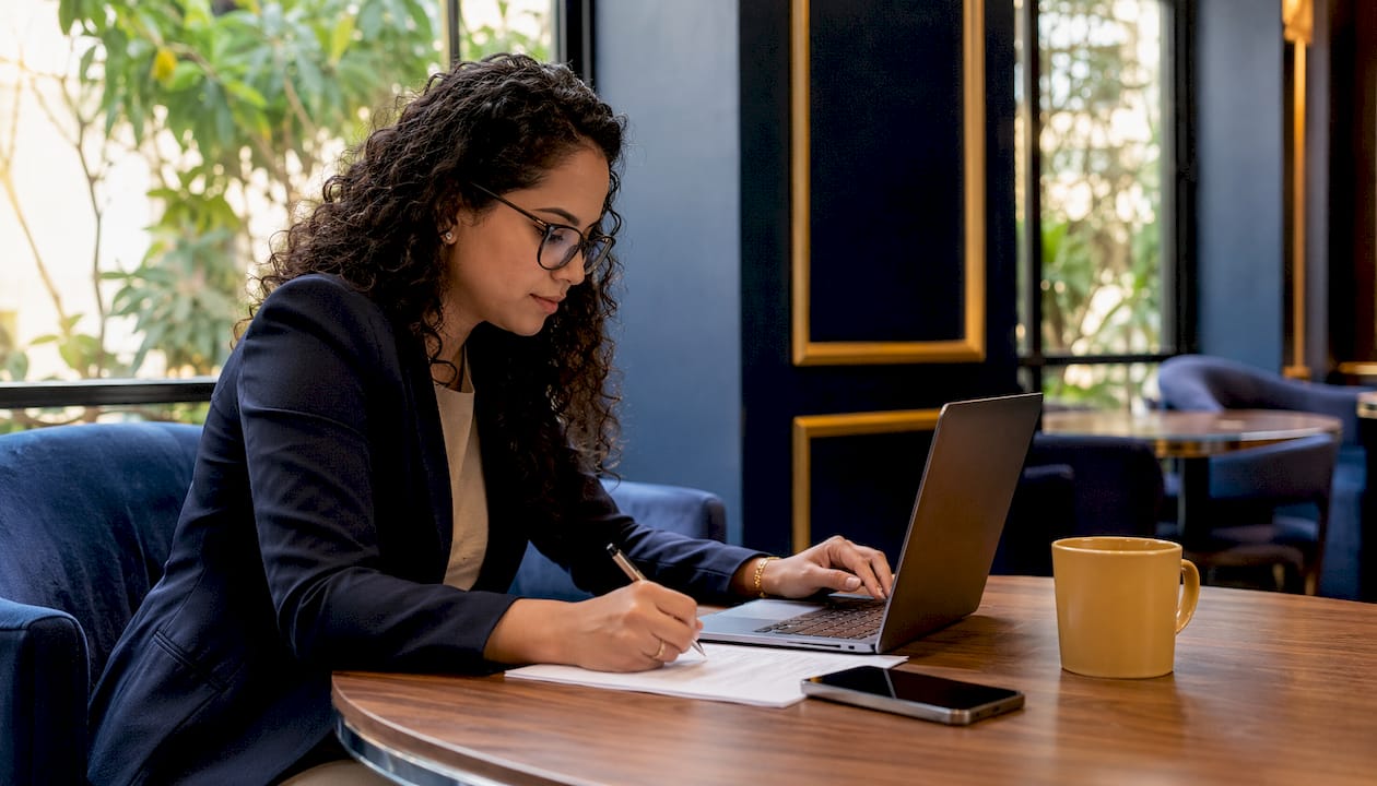 Woman taking notes on loan extension process