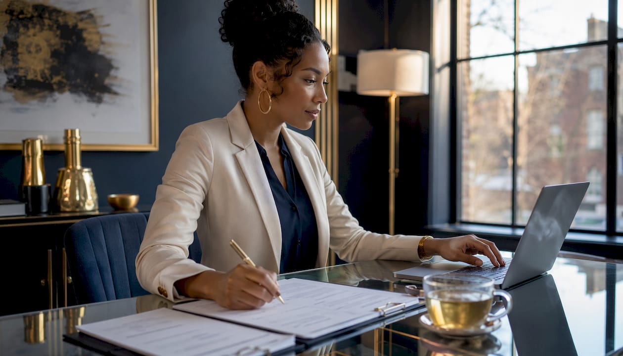 Loan officer reviewing underwriting documents at desk
