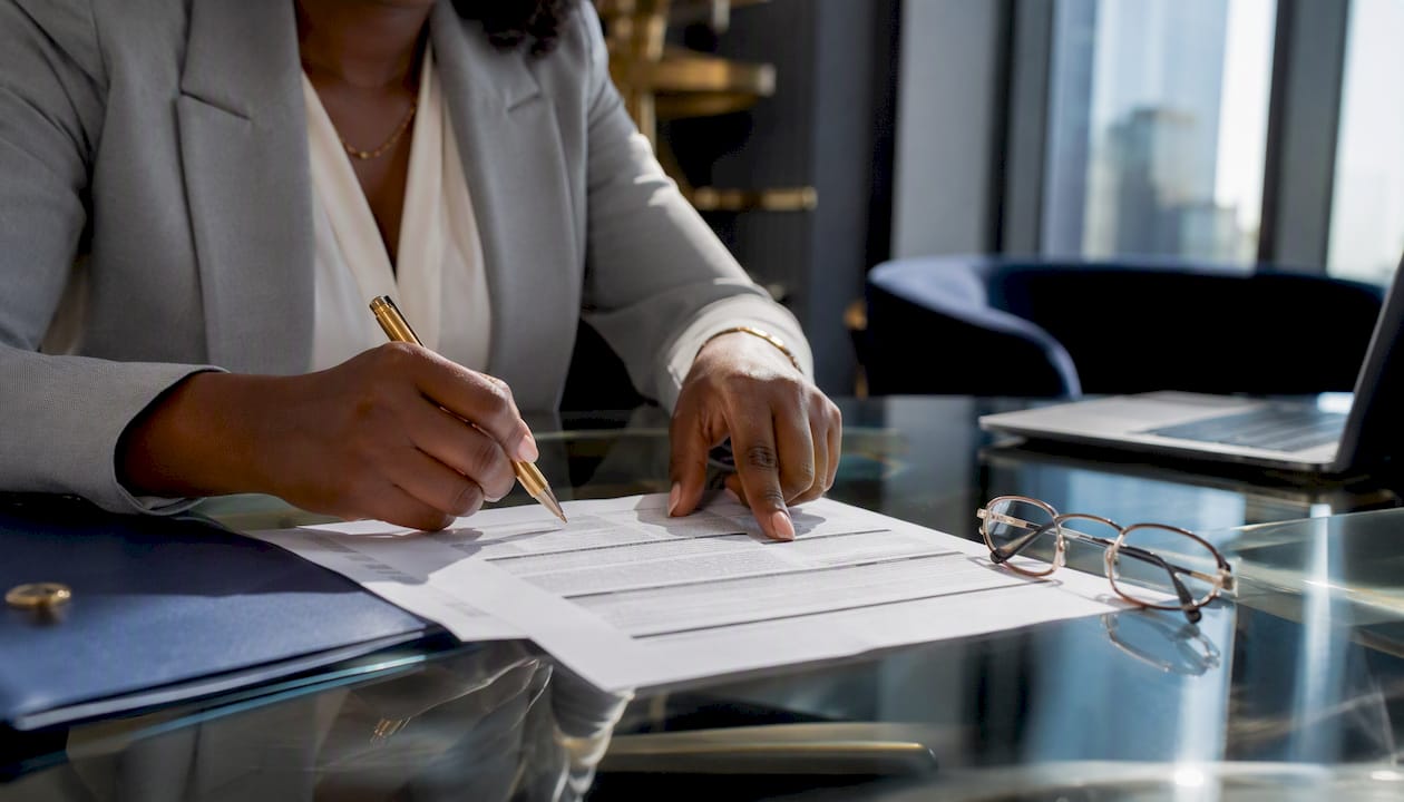 Hands pointing at loan documents on conference table