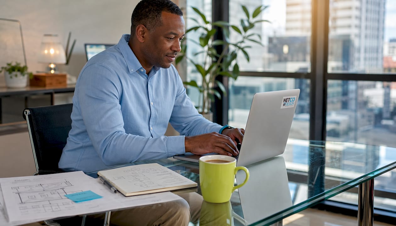 Man typing SEO strategy in kitchen