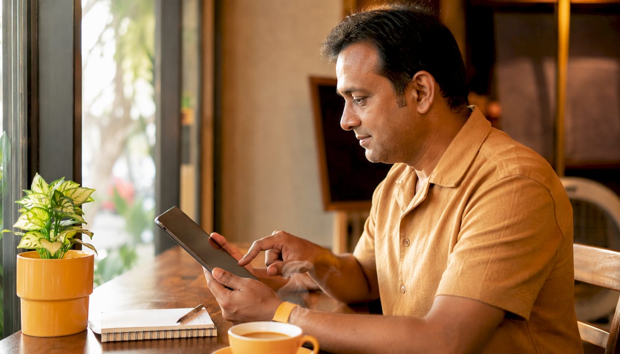 Businessman using tablet to check customer reviews