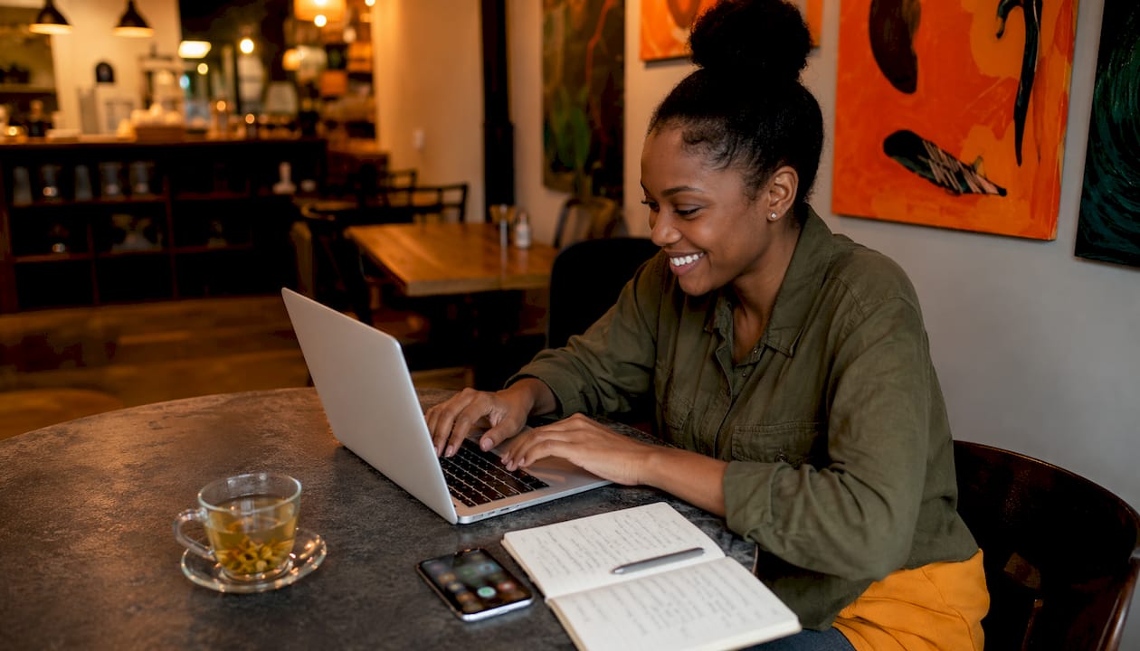 Entrepreneur typing testimonial on laptop at home office