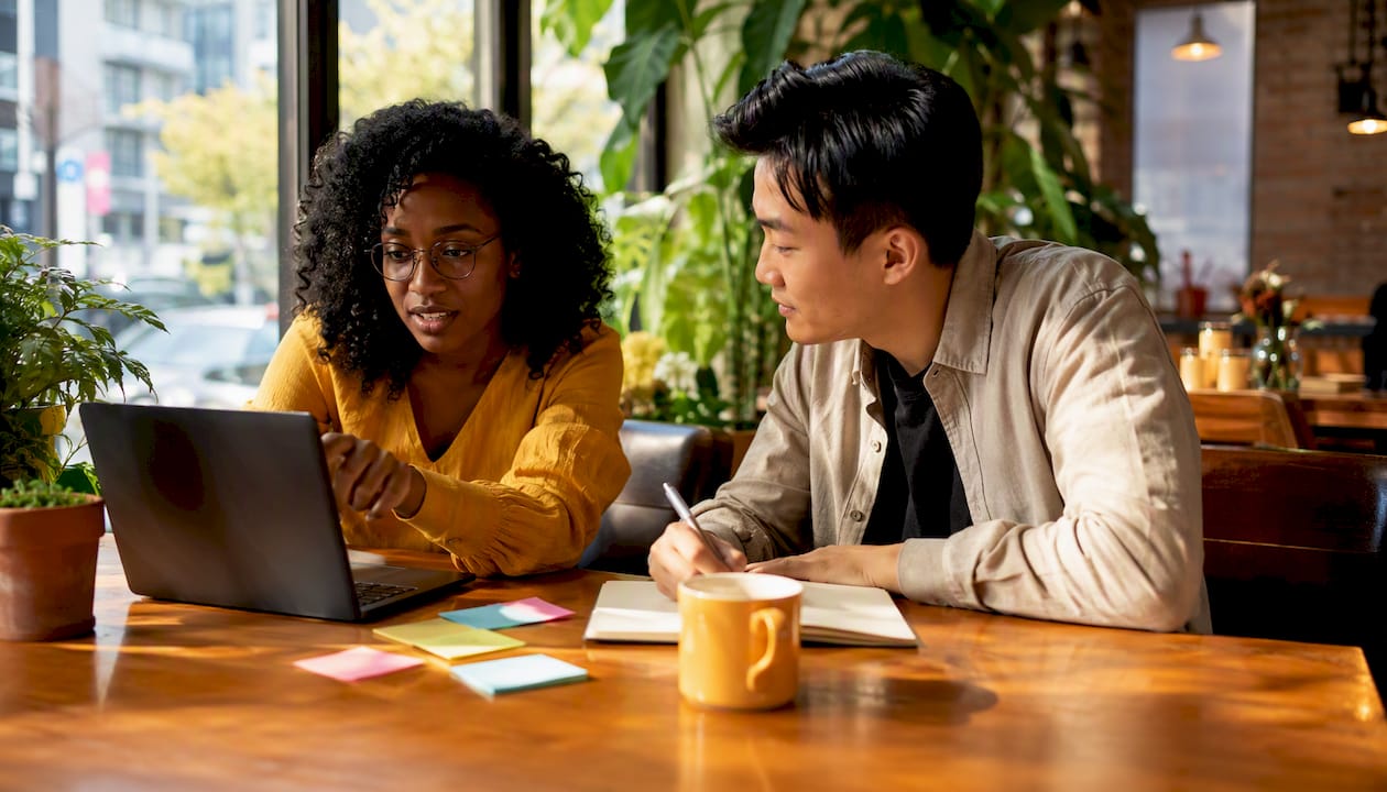 Small team collaborating using Brand24 at office desk