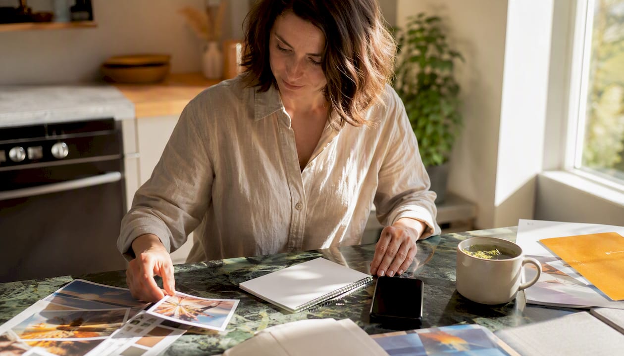 Hands arranging smartphone and materials on table