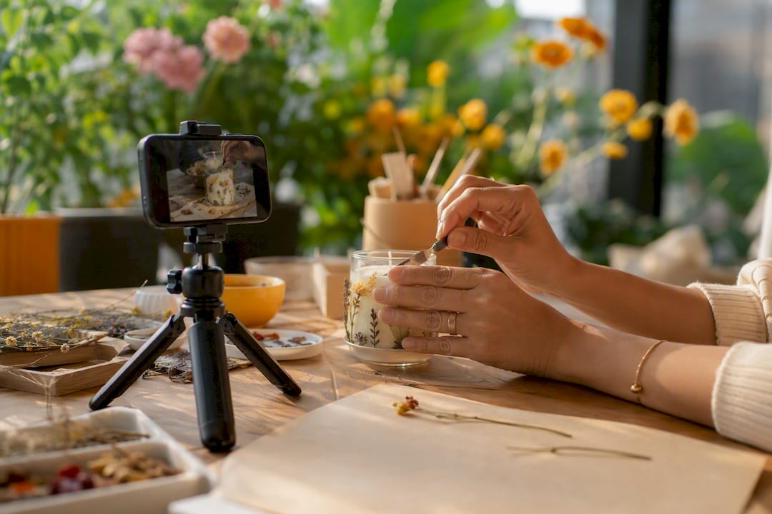 Hands recording a craft process with smartphone
