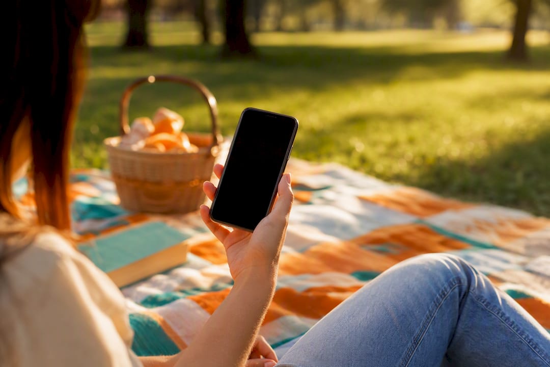 Hand holding phone testing link outdoors