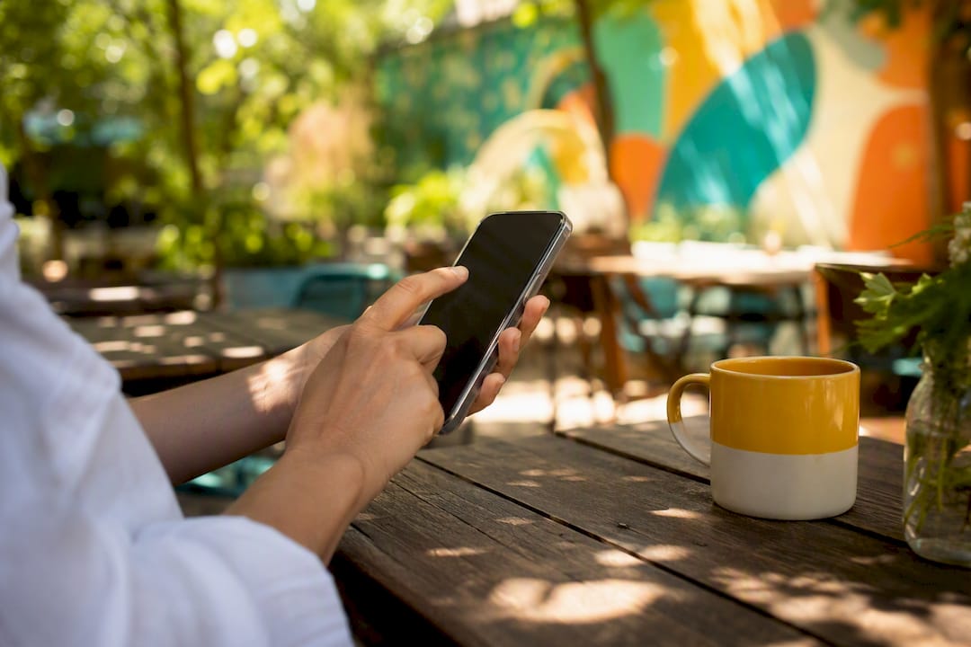 Hands adding location tag on smartphone