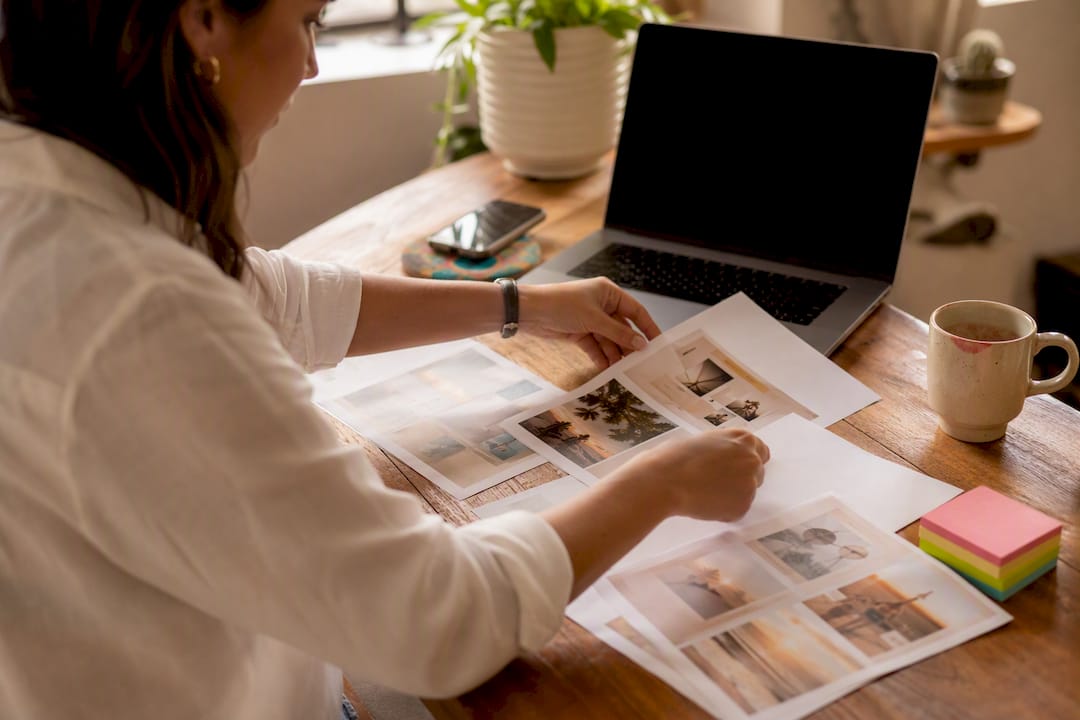 Hands arranging Instagram content briefs on table