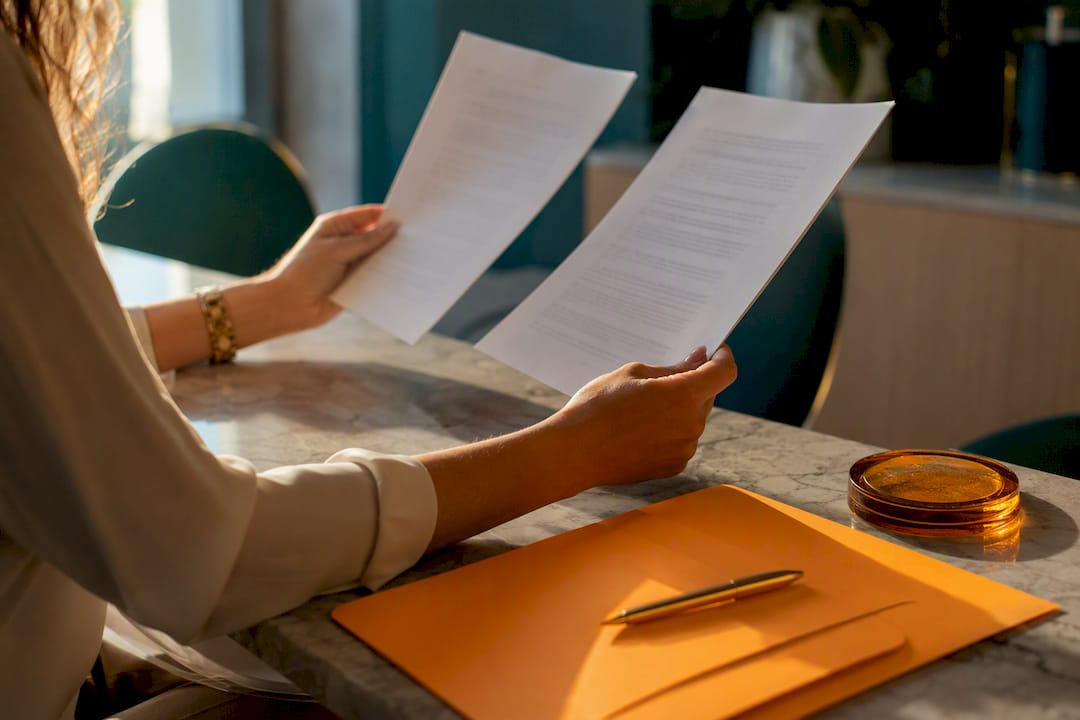 Hands reviewing small business contract clauses