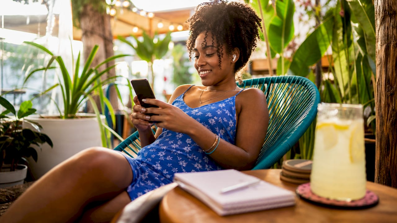 Young woman viewing music video on phone indoors