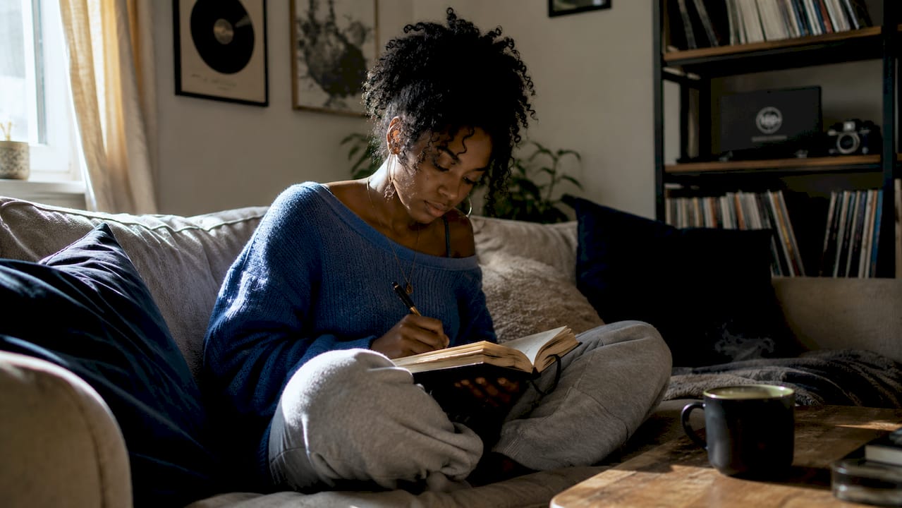 Songwriter writing lyrics at desk