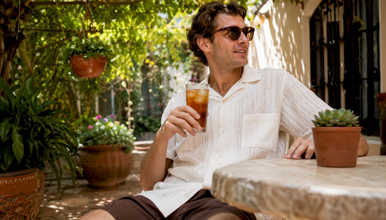 Man in Dan Flashes linen shirt at patio cafe