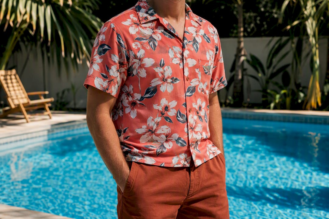 Man styled in coral floral shirt and rust shorts