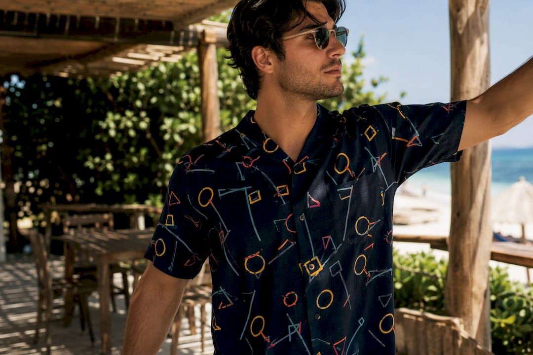 Man checking fit of Dan Flashes shirt at patio