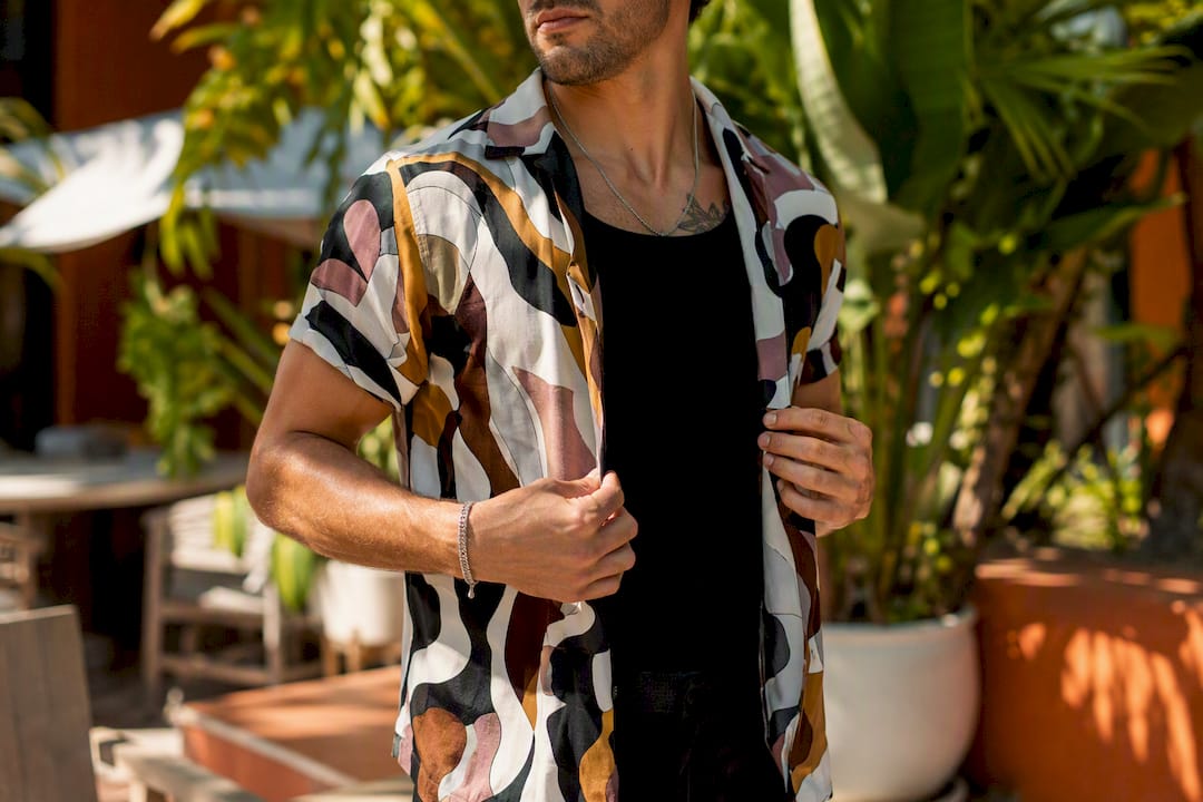 Man layering open Dan Flashes shirt over tank top