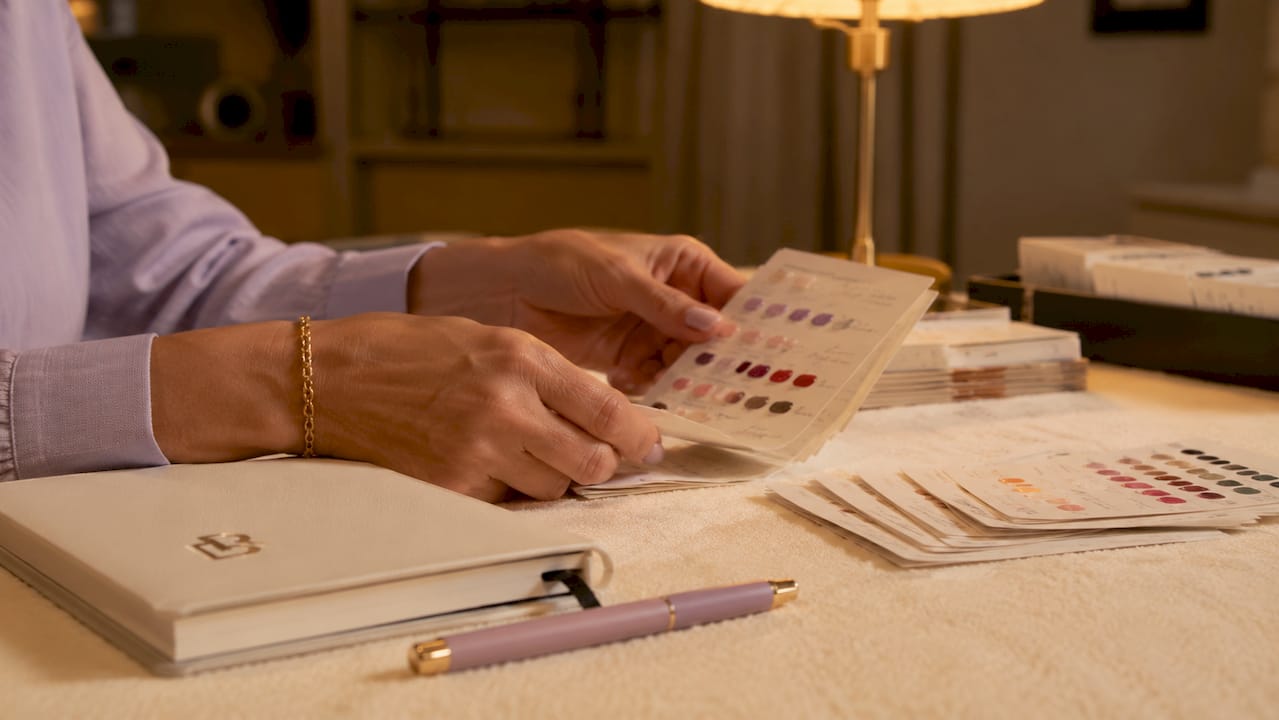 Hands sorting physical client record cards