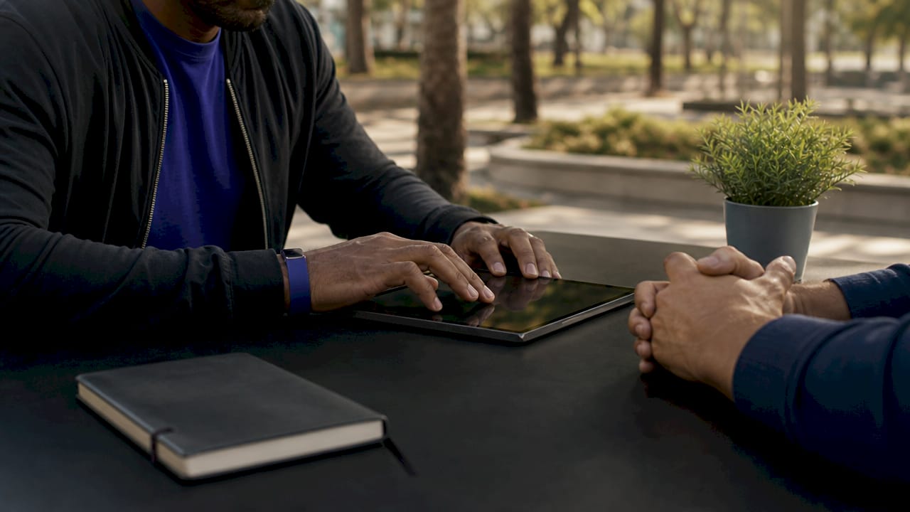 Hands interacting with tablet in café setting