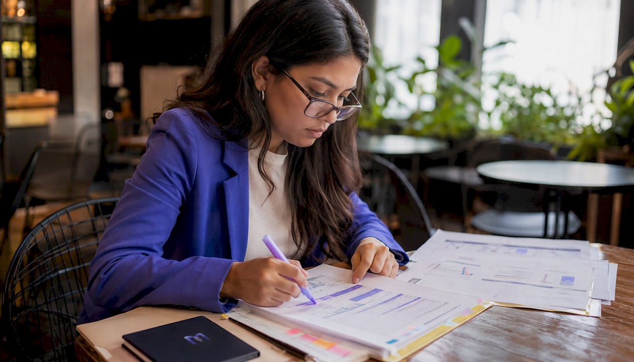 Workforce manager reviewing staffing analytics at meeting table