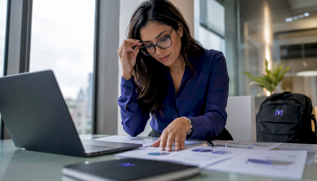 Business analyst reviewing ROI metrics reports