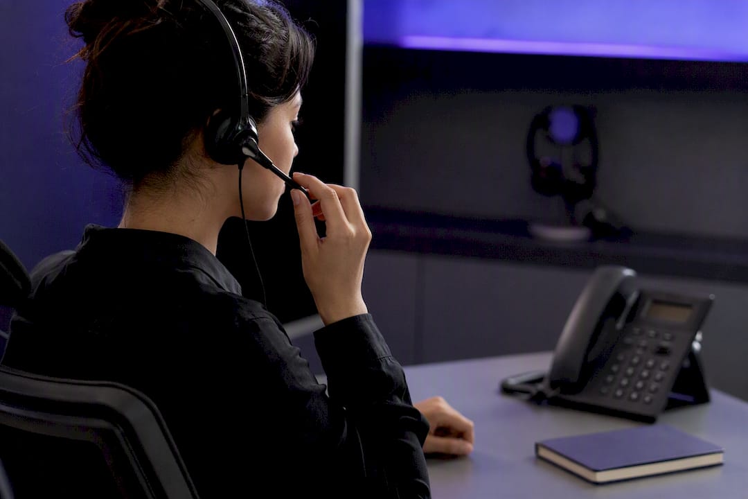 Hand holding call center headset microphone