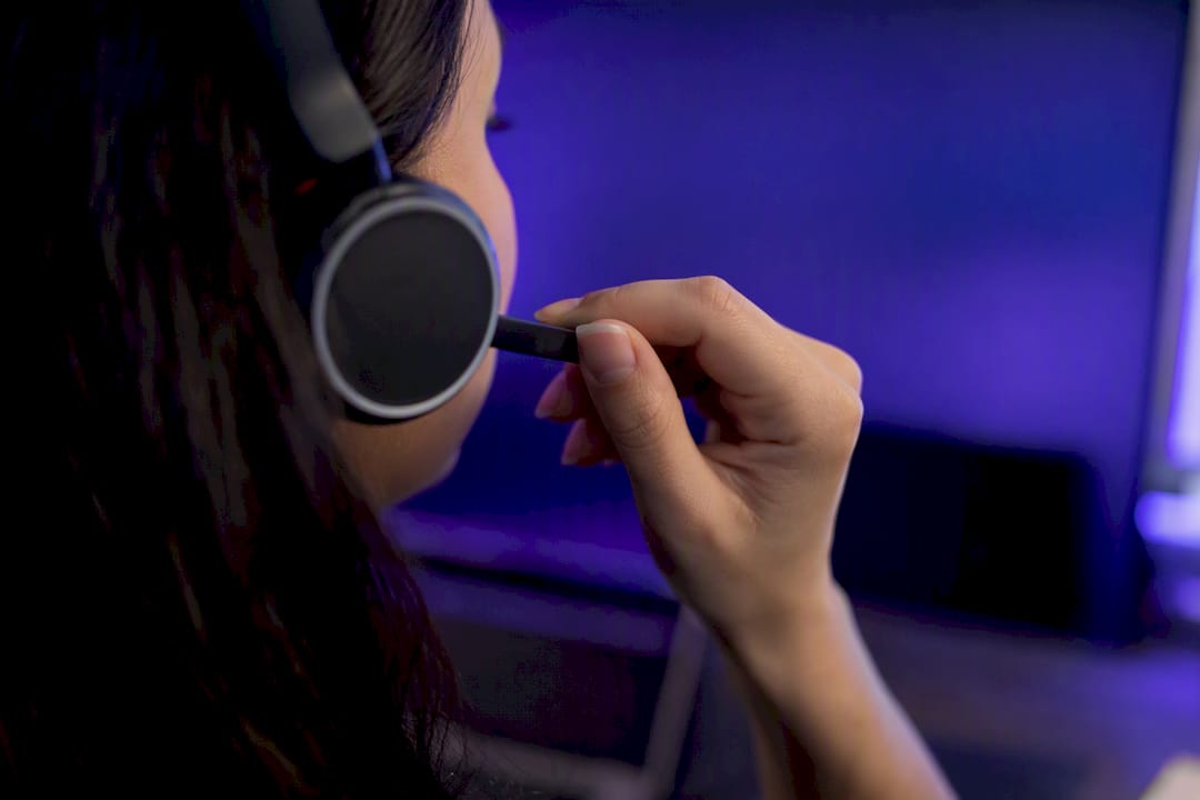Hand adjusting headset microphone
