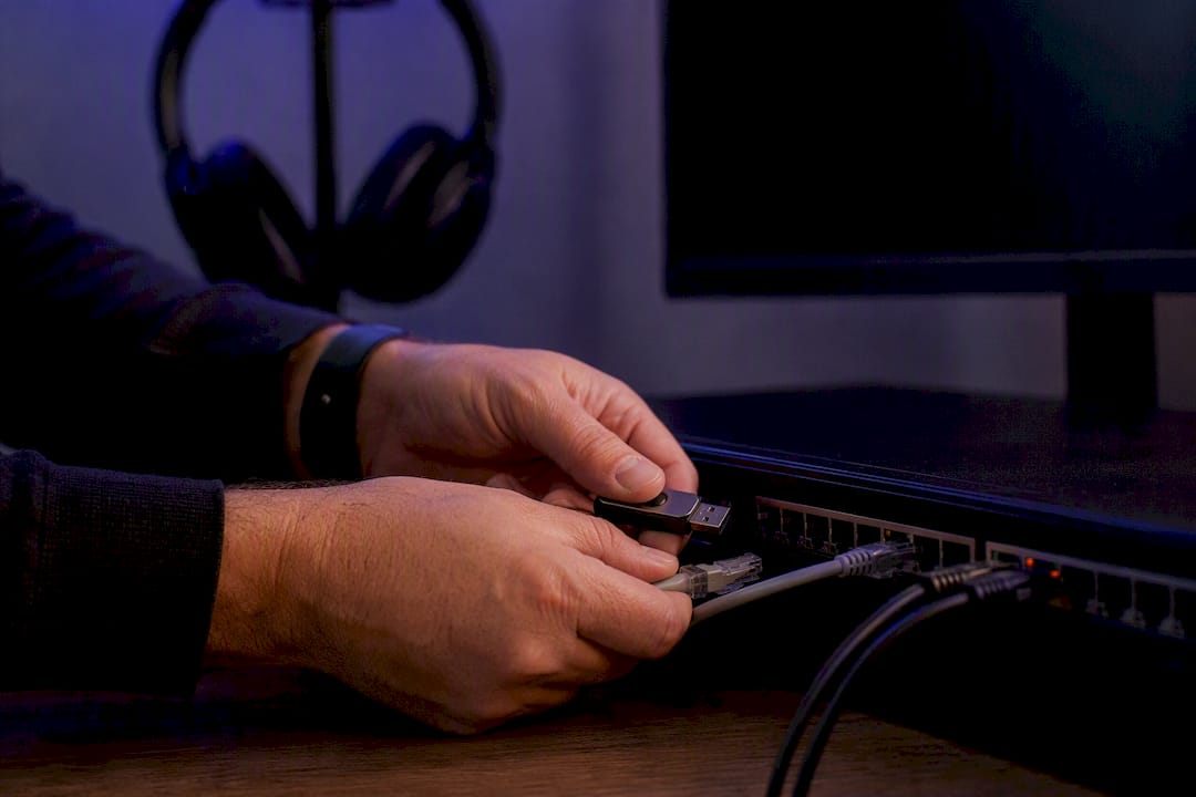 Hands adjusting secure hardware token on dark desk