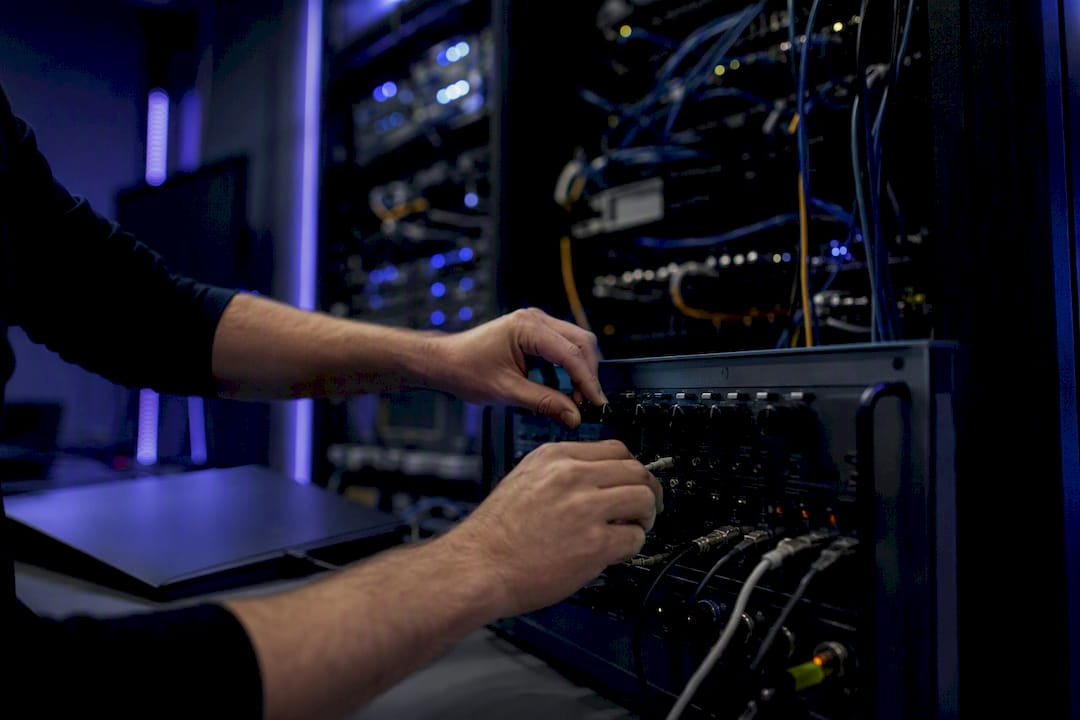 Hands adjusting load testing device in server room