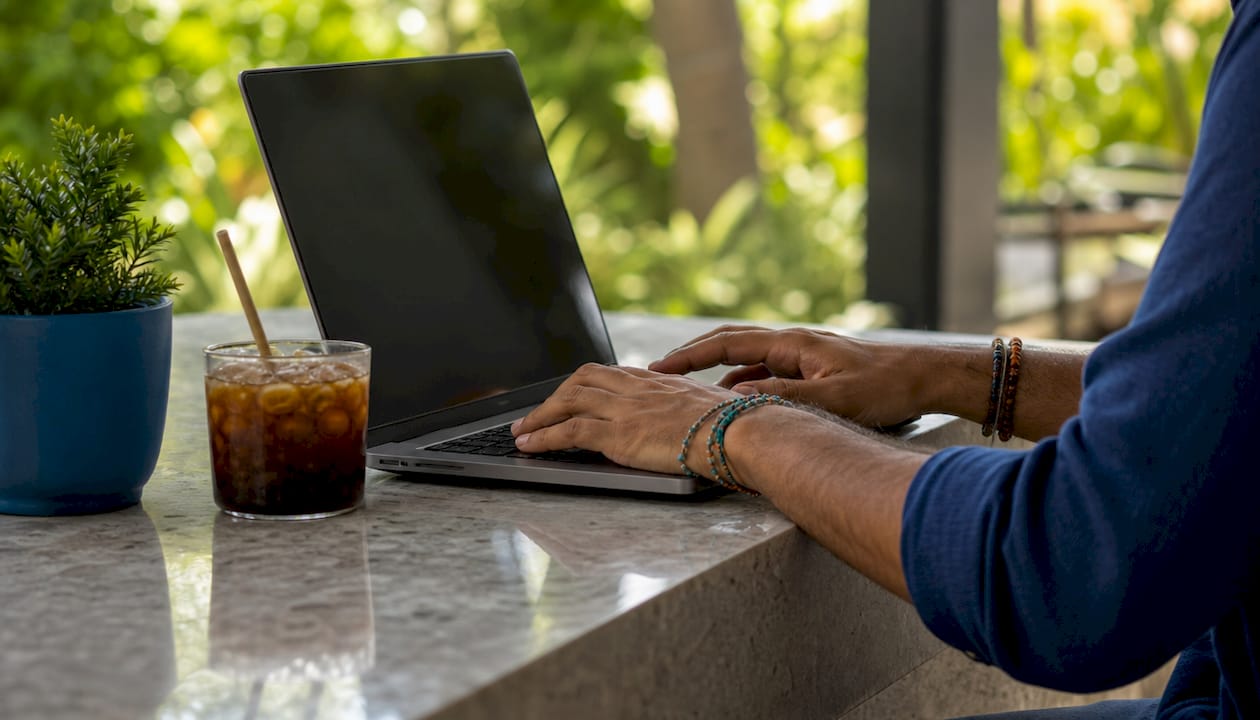 Hands typing on laptop showing social media privacy risks