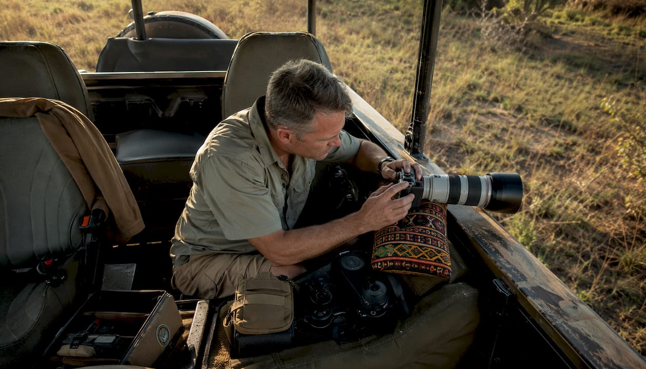 Photographic safari vehicle interior and photographer