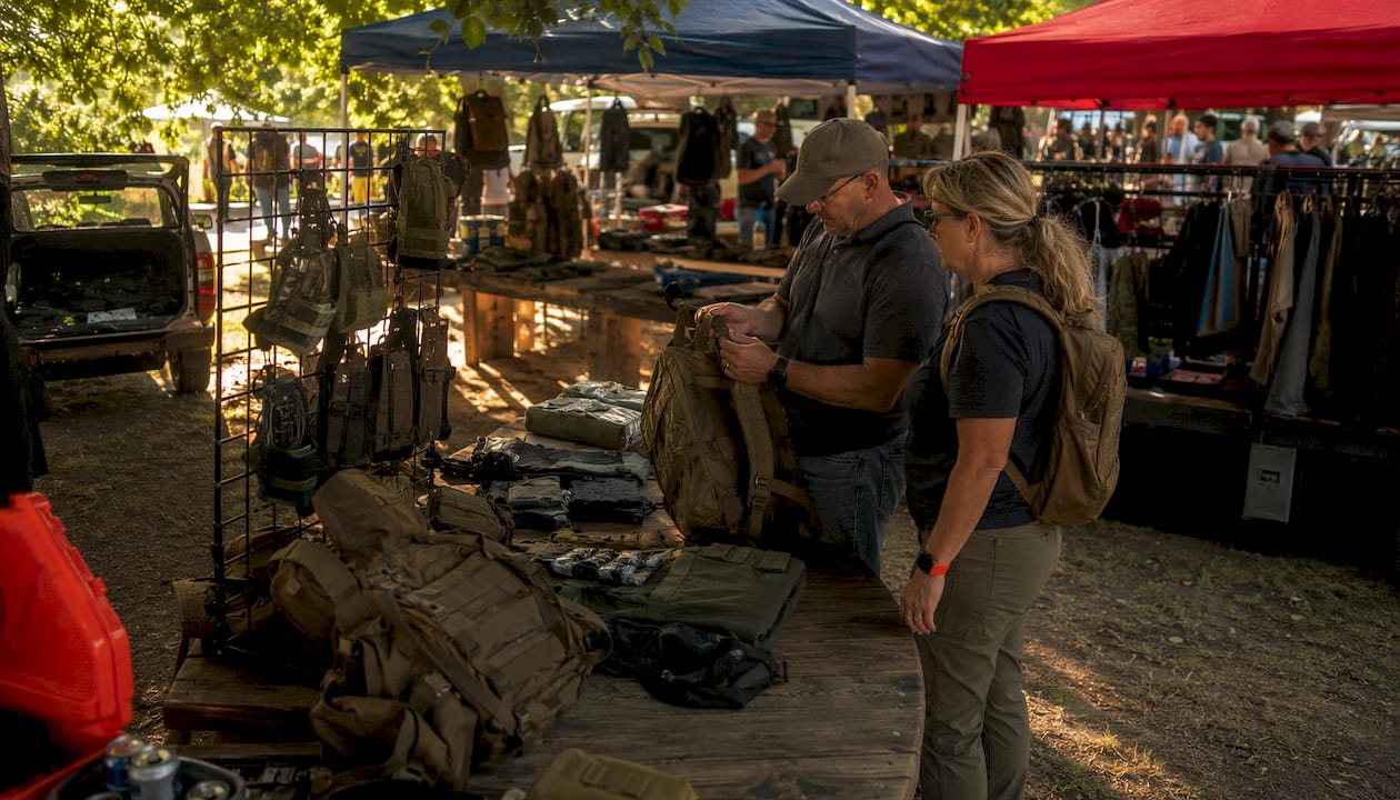 Couple evaluating tactical gear in store aisle