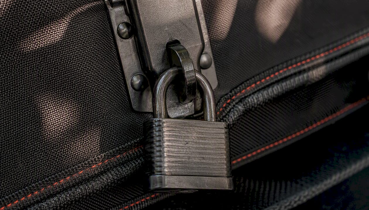Heavy-duty padlock securing gun case latch