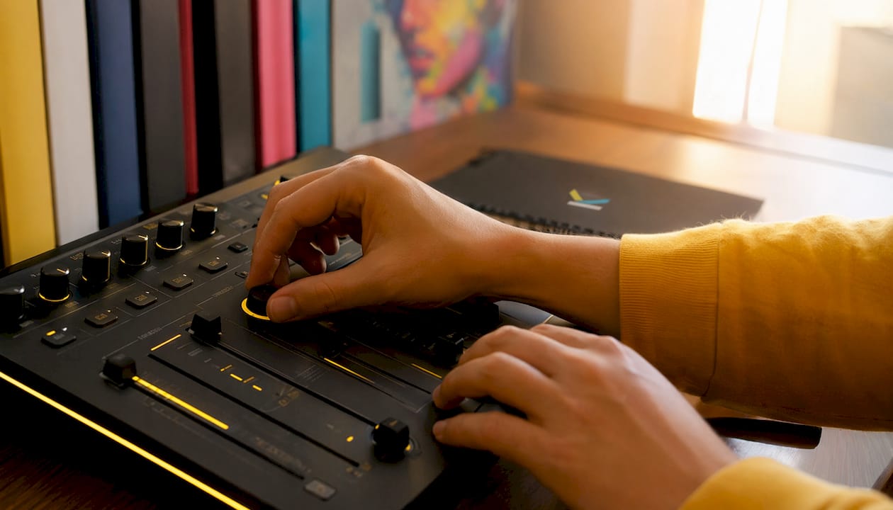 Hands controlling video effects hardware close-up