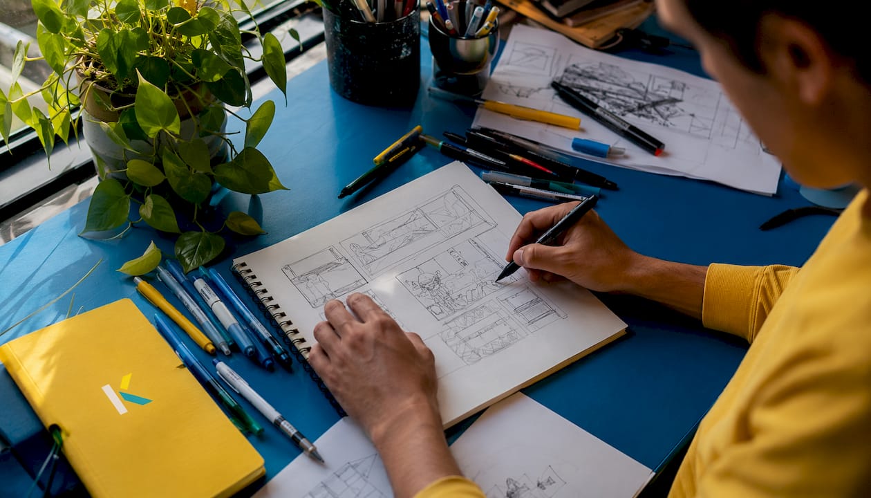 Artist drawing storyboard panels by hand