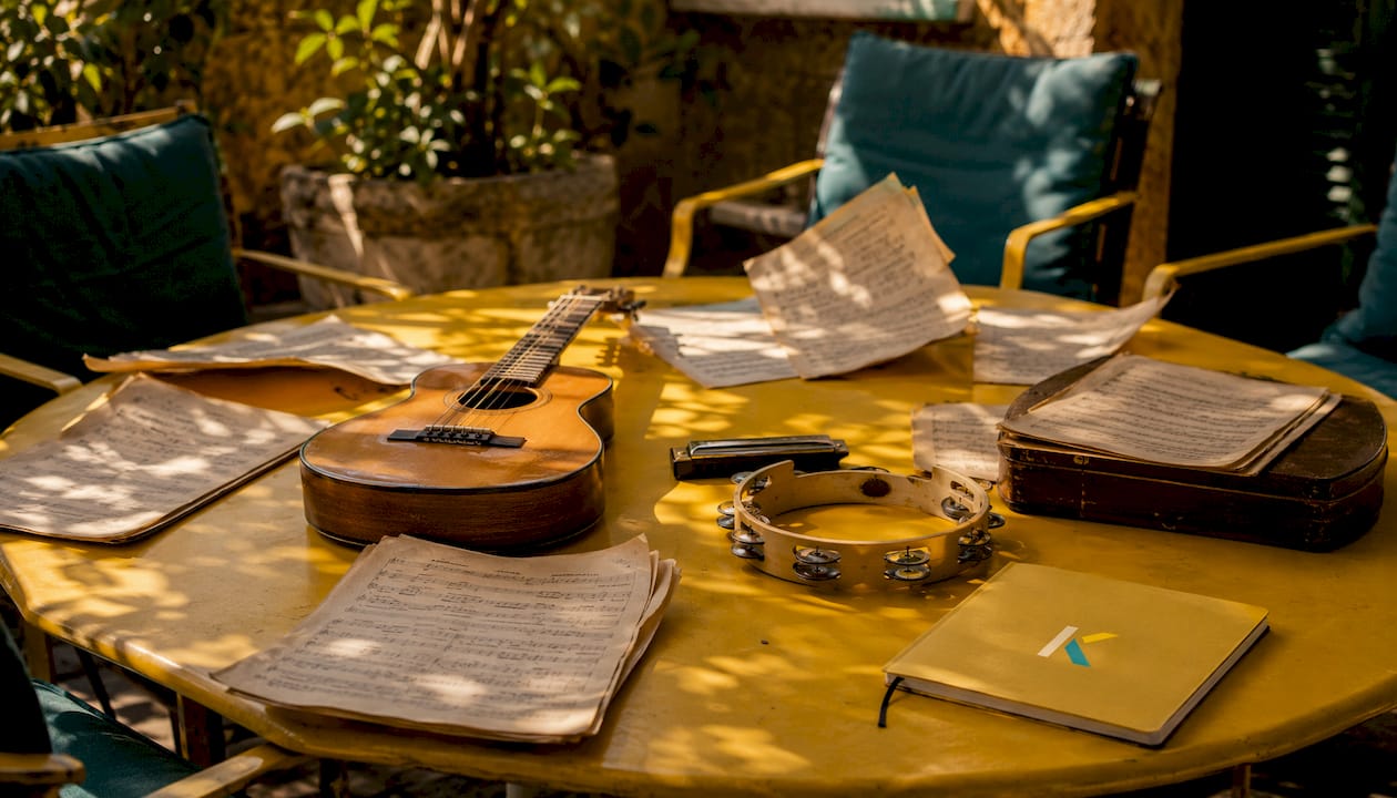 Music instruments and sheet music on wooden table