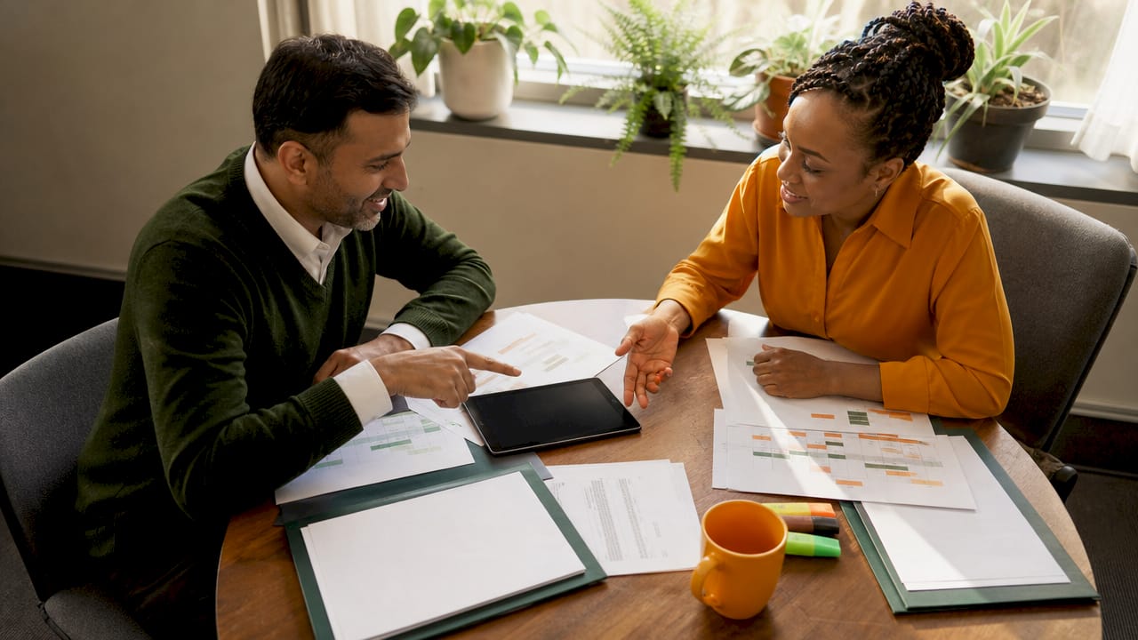 Two HR professionals discussing relocation communication