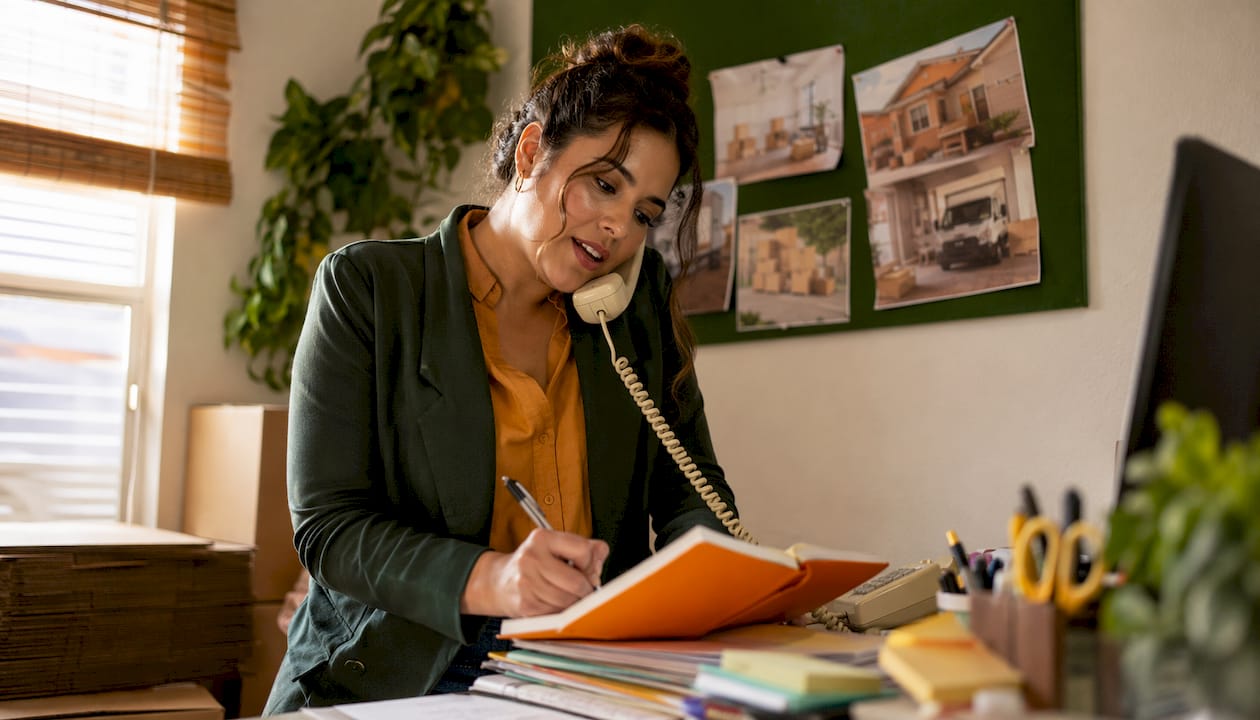 Woman coordinating local moving logistics in office
