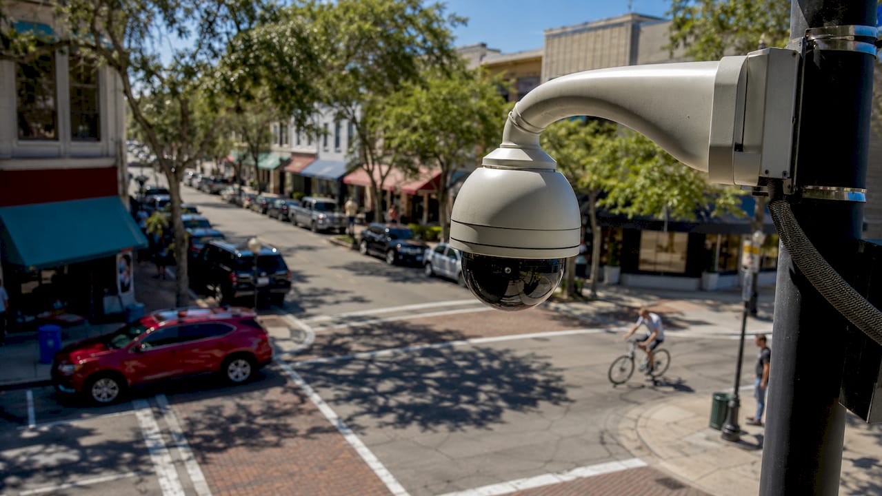 Surveillance camera monitoring urban street corner