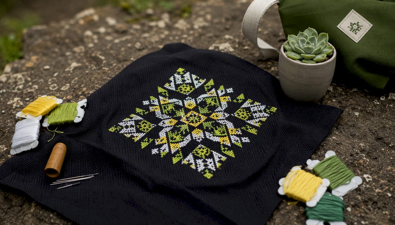 Overhead view of colorful stitches on dark fabric