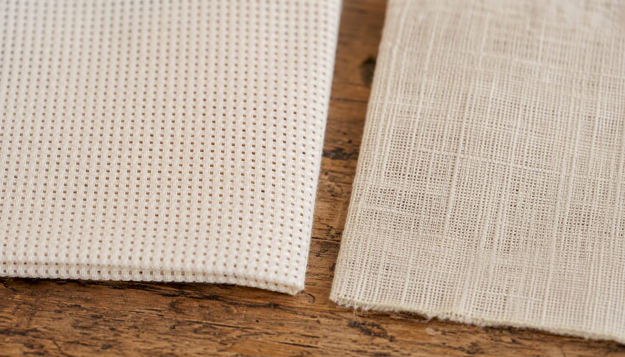 Close-up comparison of Aida and evenweave fabric weave