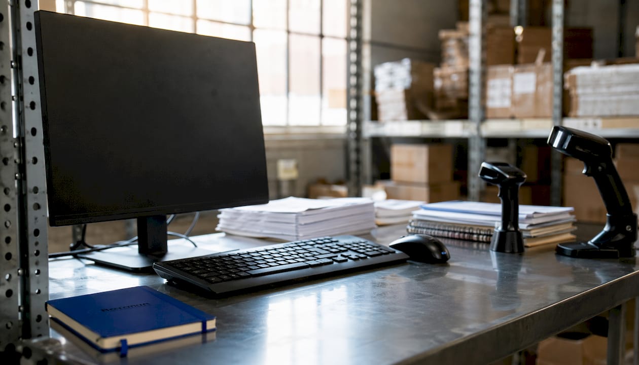 Warehouse office workstation with ERP inventory tools