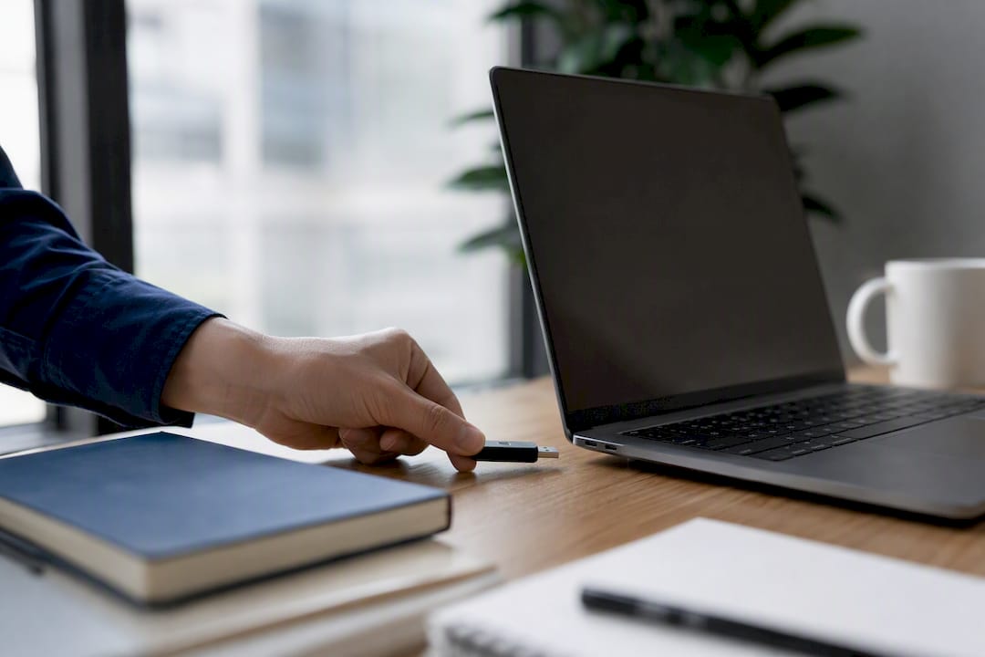 Hand unplugging USB drive in office