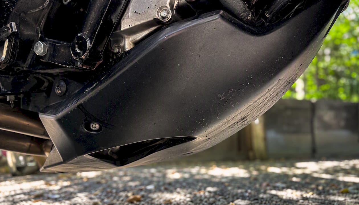 Close-up underside motorcycle belly pan