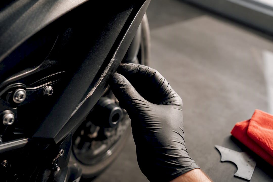 Scuffed motorcycle fairing beside crash protection
