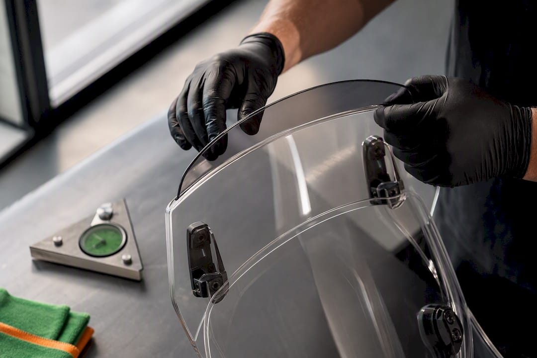 Technician aligning motorcycle wind deflector