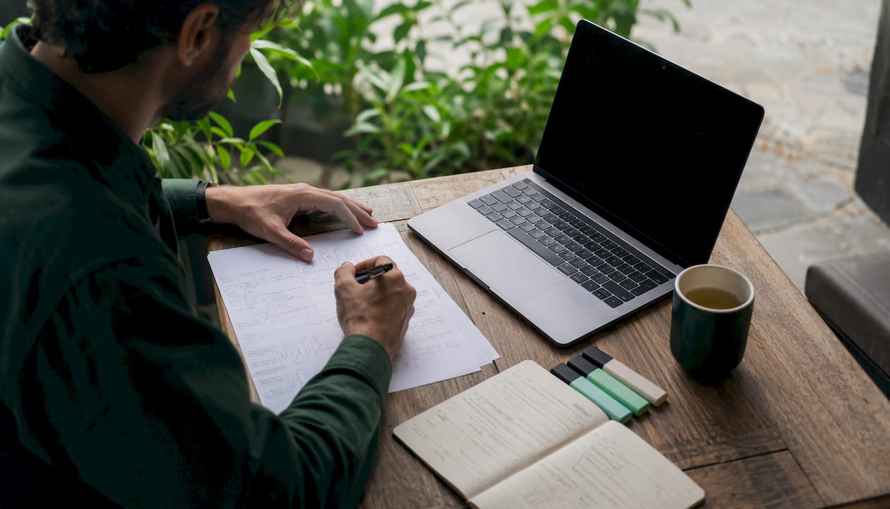 Hands typing analytics code on laptop keyboard