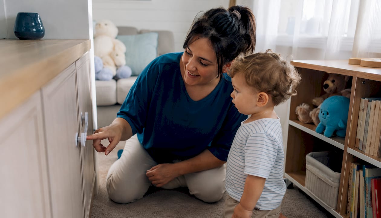 Parent installing child safety locks in mobile home