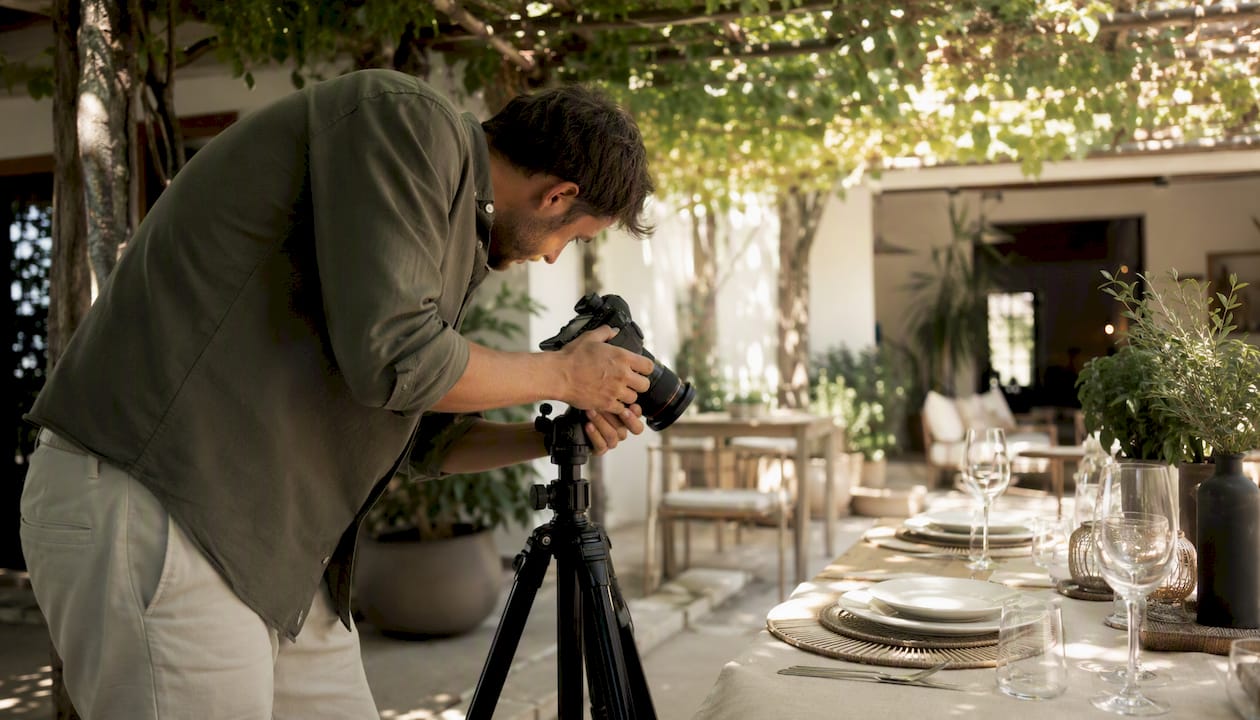 Photographer adjusting camera in hotel room